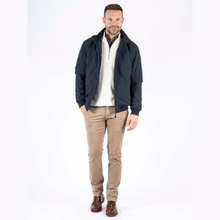 Load image into Gallery viewer, Man wearing a navy jacket, white sweater, beige pants, and brown shoes on a white background