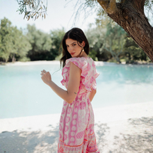 Load image into Gallery viewer, Woman in a pink dress standing by a tree by a body of water