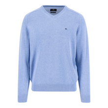 Load image into Gallery viewer, Light blue sweater with a small logo on a white background
