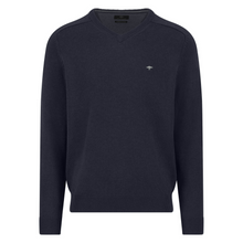 Load image into Gallery viewer, Navy sweater with a small logo on a white background