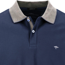 Load image into Gallery viewer, Navy polo shirt with a textured collar and brand logo on a white background