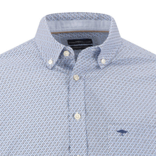 Load image into Gallery viewer, Close-up of a light blue and white micro-patterned button-down shirt with a small navy embroidered logo on the chest.