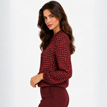 Load image into Gallery viewer, A woman wearing a textured red and black tweed long-sleeve blouse with burgundy pants, photographed against a clean white studio background.