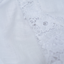 Load image into Gallery viewer, Close-up of a white lace garment on a light gray background