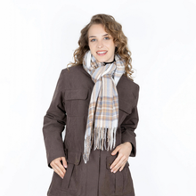 Load image into Gallery viewer, A woman with curly light brown hair wearing a dark brown coat and a cream, beige, and light blue plaid scarf with fringe, posing against a solid white background.