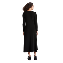 Load image into Gallery viewer, female model with arms down by side wearing marco polo jersey dress in black colour