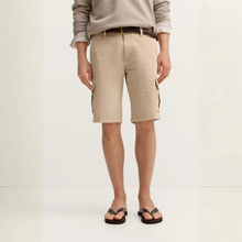 Load image into Gallery viewer, Person wearing beige cargo shorts on a plain background