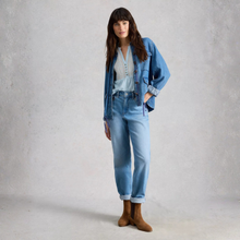 Load image into Gallery viewer, Woman wearing a denim jacket and jeans standing against a plain background