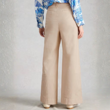 Load image into Gallery viewer, Person wearing beige wide-leg pants with a blue floral blouse on a plain background