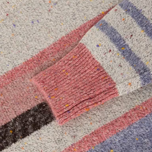 Load image into Gallery viewer, Close-up of a textured knit sweater with a chunky ribbed cuff, featuring a speckled cream base with pink, dusty blue, and dark brown stripes.