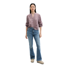 Load image into Gallery viewer, Woman wearing a patterned blouse and blue jeans on a white background