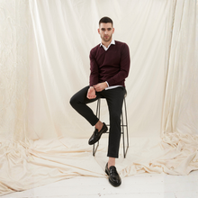 Load image into Gallery viewer, Man sitting on a stool wearing a burgundy sweater and black pants against a plain background