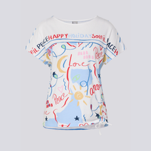 Load image into Gallery viewer, White t-shirt with colorful text and graphics on a light gray background