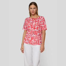 Load image into Gallery viewer, Red & White print top on lady with white trousers