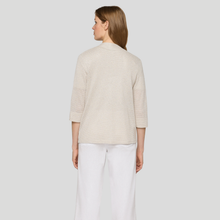 Load image into Gallery viewer, Woman wearing a beige cardigan and white pants on a plain background
