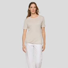Load image into Gallery viewer, Woman wearing a beige top and white pants on a light gray background