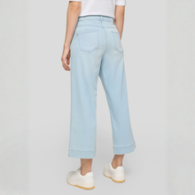 Load image into Gallery viewer, Light blue jeans worn by a person on a plain background