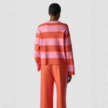 Load image into Gallery viewer, Person wearing a pink and orange striped sweater with matching pants on a light gray background