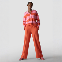 Load image into Gallery viewer, Person wearing a pink and orange striped sweater with matching pants on a light gray background