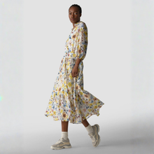 Load image into Gallery viewer, Woman wearing a floral dress with a plain background