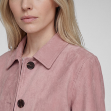 Load image into Gallery viewer, Close-up of a model wearing a dusty pink suede or micro-suede collared jacket with dark brown buttons, against a light gray background.