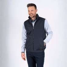 Load image into Gallery viewer, Man wearing a navy vest over a light blue shirt on a white background