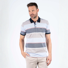 Load image into Gallery viewer, Man wearing a striped polo shirt on a white background