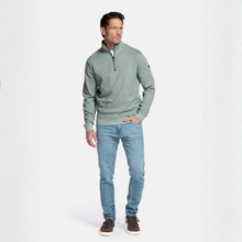 Load image into Gallery viewer, Man wearing a green sweater and light blue jeans on a white background