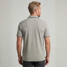 Load image into Gallery viewer, Man wearing a light gray polo shirt against a plain background