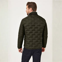 Load image into Gallery viewer, A man viewed from the back wearing an olive green quilted puffer jacket and dark blue jeans, standing against a light off-white studio background.