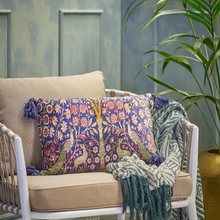 Load image into Gallery viewer, Decorative pillow with floral pattern on a beige sofa with a green blanket, against a light blue wall.