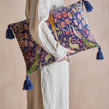 Load image into Gallery viewer, Person holding two decorative pillows with floral and animal patterns on a beige background