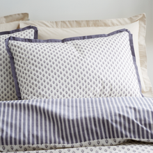 Load image into Gallery viewer, Patterned pillows and bedspread with blue and white stripes on a neutral background
