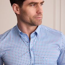 Load image into Gallery viewer, Man wearing a blue patterned shirt against a neutral background