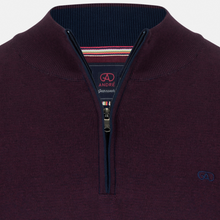 Load image into Gallery viewer, Close-up of a maroon sweater with a zipper and visible brand logo on a light gray background