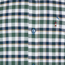Load image into Gallery viewer, Close-up of a green and white checkered shirt with a brand logo.