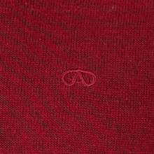 Load image into Gallery viewer, Close-up of a red fabric with a small logo in the center.
