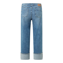 Load image into Gallery viewer, Blue jeans with a brand label on a white background