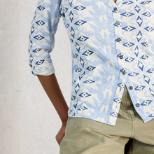 Load image into Gallery viewer, Light blue patterned shirt with rolled-up sleeves worn by a person on a plain background