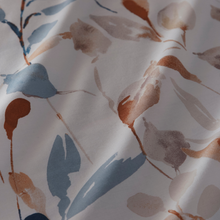 Load image into Gallery viewer, Close-up of fabric with floral pattern featuring blue, brown, and beige leaves on a white background.