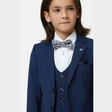 Load image into Gallery viewer, Child wearing a blue suit with a white shirt and patterned bow tie on a light gray background