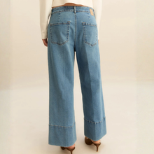 Load image into Gallery viewer, Blue jeans worn by a person on a plain background