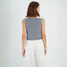 Load image into Gallery viewer, Woman wearing a sleeveless striped shirt and white pants on a plain background