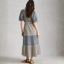 Load image into Gallery viewer, Woman wearing a patterned dress against a plain background