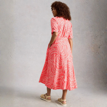 Load image into Gallery viewer, Woman wearing a pink tie-dye dress against a gray background