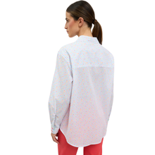 Load image into Gallery viewer, Back of Woman wearing a white patterned shirt and red pants on a white background