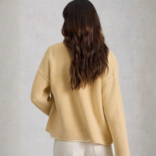 Load image into Gallery viewer, Back view of Model wearing White Stuff Gigi Washed Cardi in light yellow, with a light grey background.