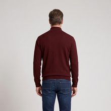 Load image into Gallery viewer, A man viewed from behind wearing a dark burgundy mock-neck knit sweater and blue jeans, standing against a plain light gray studio background.