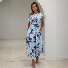 Load image into Gallery viewer, Woman wearing a floral one-shoulder dress in a minimalistic setting