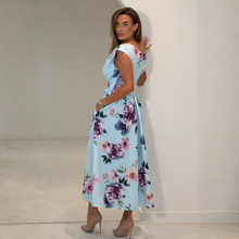 Load image into Gallery viewer, Woman wearing a floral dress against a plain background
